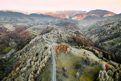 Aerial view of winding road against mountain at sunrise