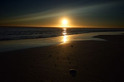 Scenic view of beach against sky during sunset