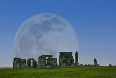 A full moon illuminating the ancient circle at stonehenge, wiltshire, uk