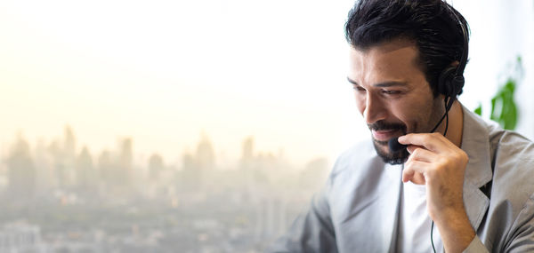 Man looking away while using mobile phone