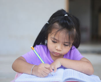 Cute girl looking at book