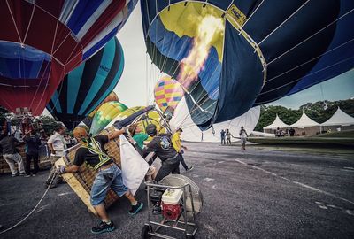 People in hot air balloon against sky