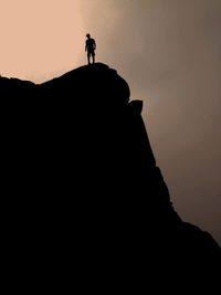 Low angle view of silhouette mountain against sky at sunset