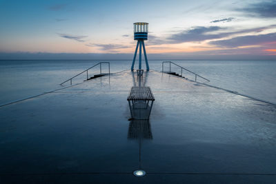 Sailboat in sea against sky during sunset