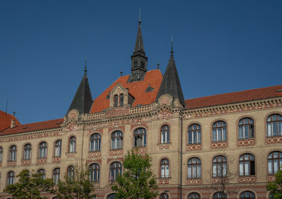 Low angle view of historic building against clear blue sky