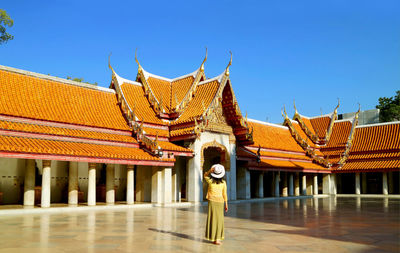 Woman being impressed by the cloister of wat benchamabophit  marble temple, bangkok, thailand