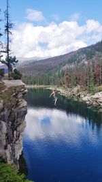 Scenic view of lake against sky and cliff jumping