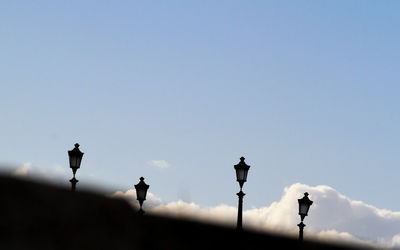 Backlit street lamps on the cestio bridge in rome