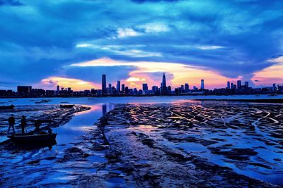 City at waterfront during sunset