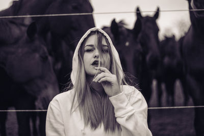 Portrait of young woman standing outdoors