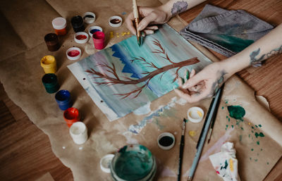 High angle view of woman painting at table