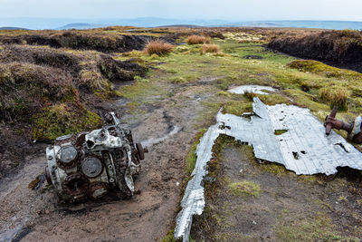 High angle view of abandoned car on field