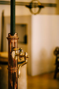 Close-up of faucet on table at home