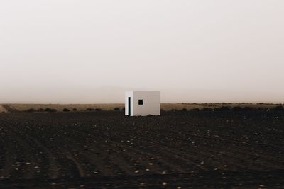 Built structure on field against clear sky