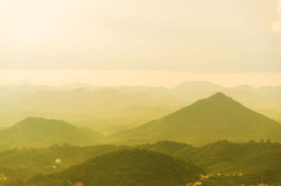 Scenic view of mountain range against sky during foggy weather