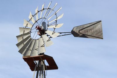 Low angle view of traditional windmill against sky