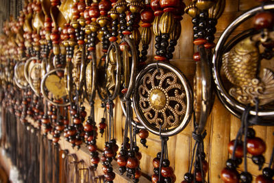 Souvenir and handicrafts made from bone. close-up of decorations hanging in store for sale