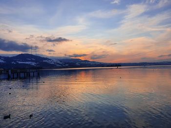 Scenic view of lake against sky during sunset