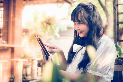 Young woman holding smart phone