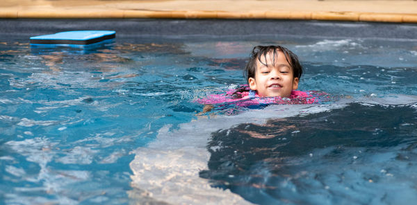 Cute girl swimming in pool