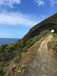 Road by sea against sky