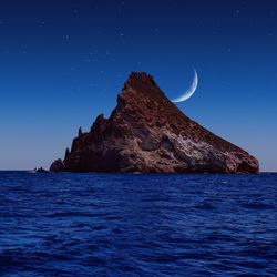 Scenic view of sea against sky at night