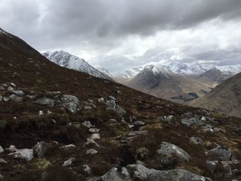 Scenic view of mountains against cloudy sky