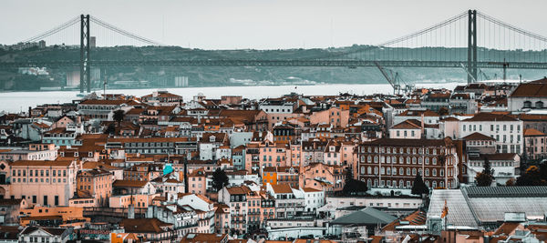 View of bridge over river against cityscape