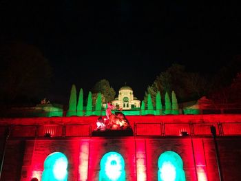 Low angle view of illuminated building against sky at night