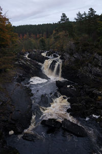 Close-up of waterfall against sky