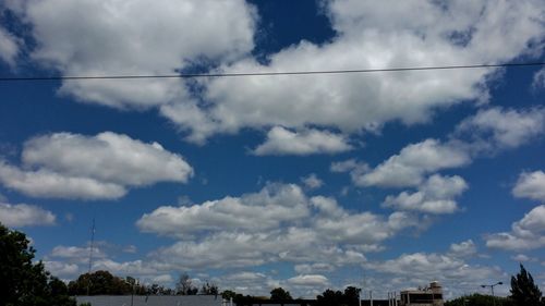 Low angle view of cloudy sky over city