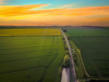 Scenic view of field against sky during sunset