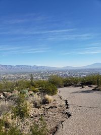 Scenic view of landscape against blue sky