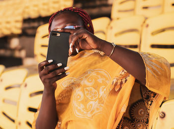 Midsection of woman using mobile phone