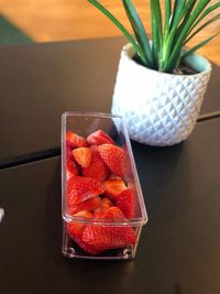 High angle view of fruits in glass container on table