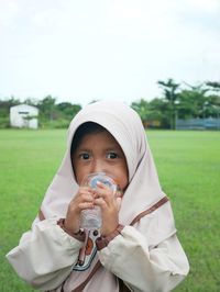 Portrait of cute girl drinking water