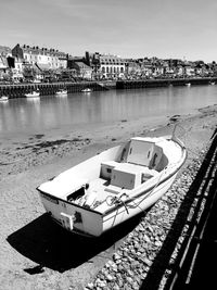 High angle view of boat moored at riverbank in city