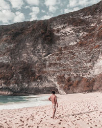 Full length of man on beach against sky