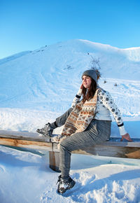 Portrait of a young woman in winter. snow, mountain, fashion, winter clothes.