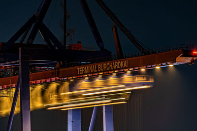 Light trails on bridge in city at night