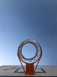 Low angle view of basketball hoop against clear sky