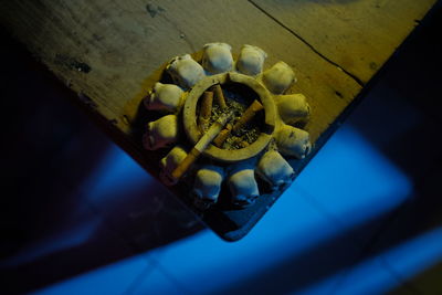 High angle view of metal container on wood