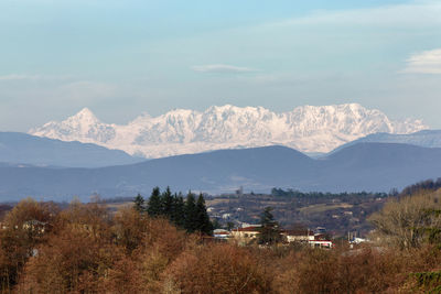 Scenic view of landscape and mountains against sky