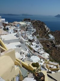 View of town by sea against sky