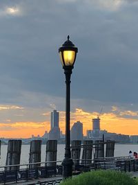 Street light with buildings in background at sunset