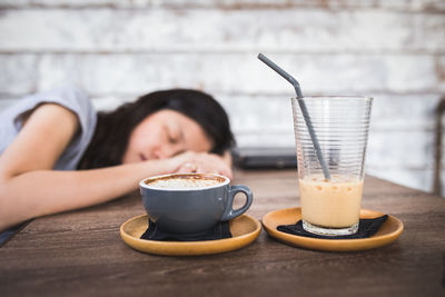 Woman drinking coffee cup on table