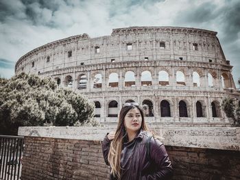 Portrait of woman against cloudy sky