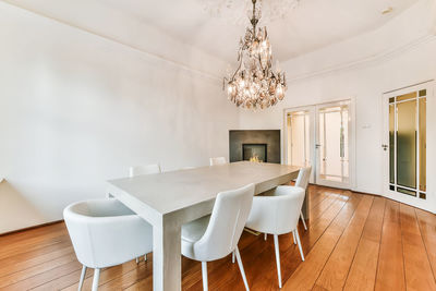 Low angle view of chandelier over dining table at home