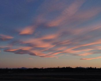 Scenic view of landscape against sky at sunset