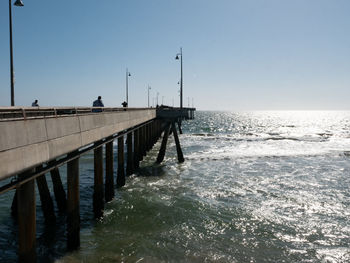 Pier over sea against clear sky